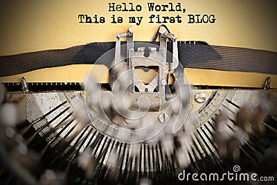 â€œHello world, this is my first blogâ€ introduction written with classic vintage typewriter on weathered paper Stock Photo